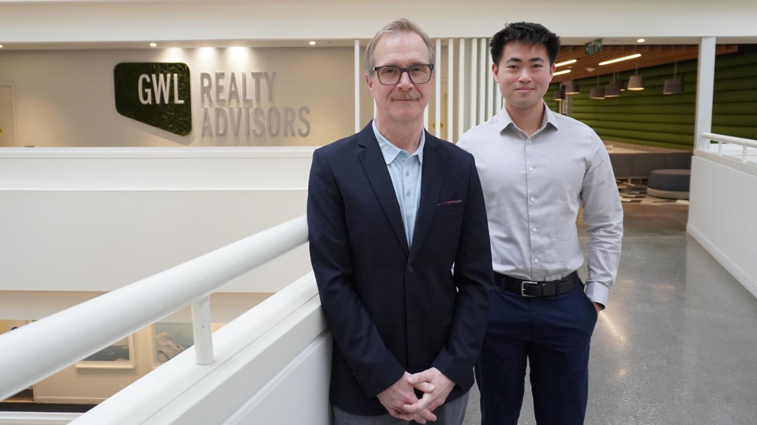 Mark Norman and Ethan Ko pose in front of the GWLRA logo